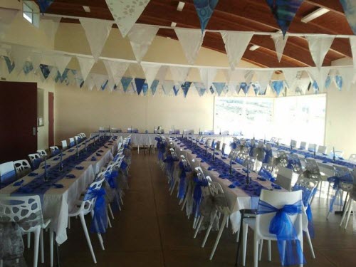 Colour-coordinated Raglan Surf Lifesaving event venue decorated with blue and white banners, ready for a community gathering or celebration.