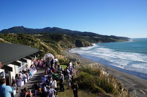 Raglan Surf Lifesaving event with crowd on the beachfront, showcasing coastal safety and community engagement in New Zealand.